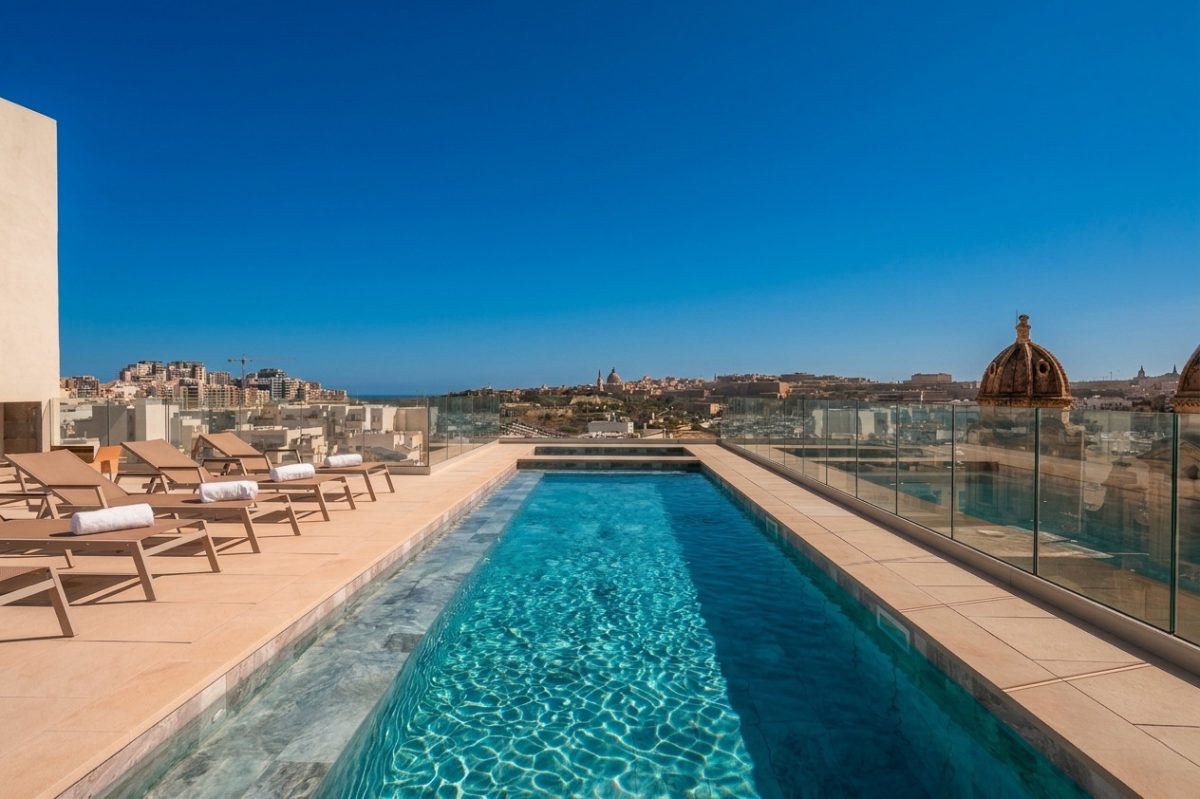 Luxury rooftop infinity pool with sea and Valletta skyline views in Malta.